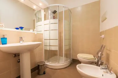 a bathroom with a shower and a toilet and a sink at A Casa Dell' Artista in Palermo
