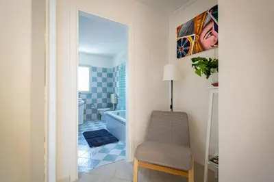 a bathroom with a chair and a bath tub at Bianca Casa in Bolognetta