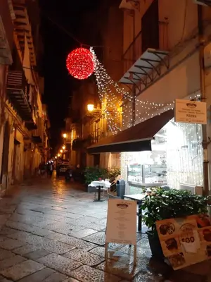 a street with christmas lights and a red ball at Dimora al Capo in Palermo
