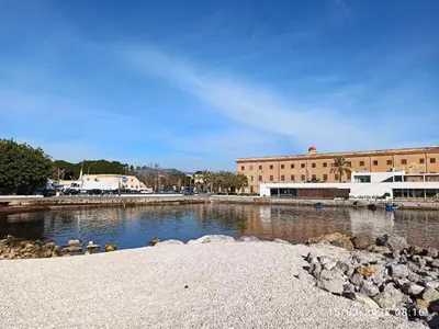 a body of water in front of a large building at 'A CASETTA RA ZIA PAOLA in Palermo