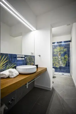 a bathroom with a sink and a toilet at Acquarò Suite Apartments in San Vito lo Capo
