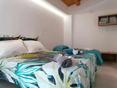 a bedroom with a bed with a colorful bedspread at Nella House in Castellammare del Golfo