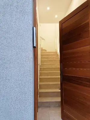 a hallway with stairs and a wooden door in a house at Nella House in Castellammare del Golfo