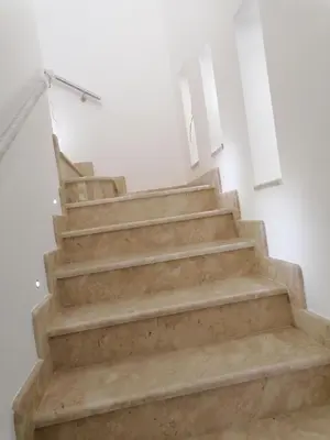 a set of stairs in a white room at Nella House in Castellammare del Golfo