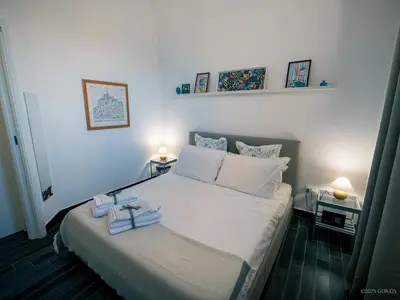 a bedroom with a bed with two towels on it at Baglio Colonna - Nature Noble Boutique in Partinico