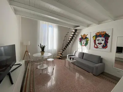 a living room with a couch and a table at Palazzo Caltagirone Suite in Palermo