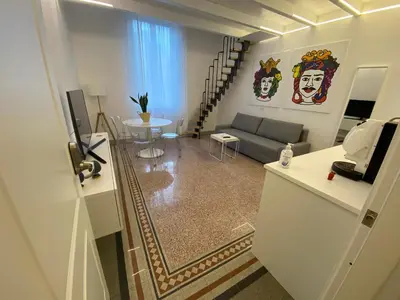 a living room with a couch and a table at Palazzo Caltagirone Suite in Palermo