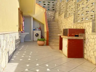a hallway of a building with a washing machine at Villa Mare Giuggiola in Alcamo Marina