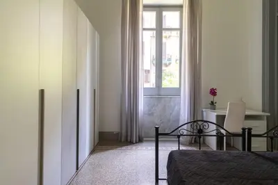 a bedroom with a bed and a window at Rome 118 in Palermo