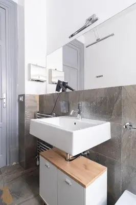 a bathroom with a white sink and a mirror at Rome 118 in Palermo