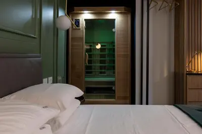 a bedroom with a bed with white sheets and a window at Vespri Luxury Rooms & Suites in Palermo