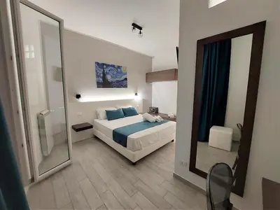 a bedroom with a bed and a large mirror at Leone Apartments in Palermo