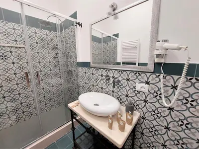 a bathroom with a sink and a shower at Leone Apartments in Palermo