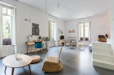 a living room with a table and chairs at Casa Roma nel Cuore di Palermo by Wonderful Italy in Palermo