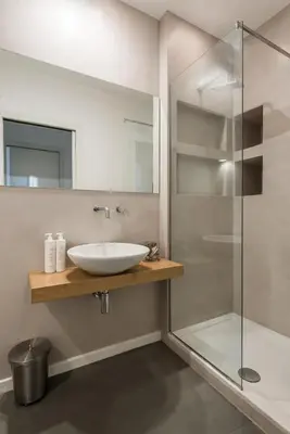 a bathroom with a sink and a glass shower at Casa Roma nel Cuore di Palermo by Wonderful Italy in Palermo