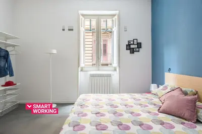 a bedroom with a bed and a window at Casa Roma nel Cuore di Palermo by Wonderful Italy in Palermo