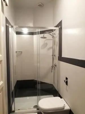 a bathroom with a glass shower with a toilet at suite ruggero settimo in Palermo