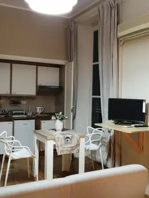 a kitchen with a table with a computer on it at suite ruggero settimo in Palermo
