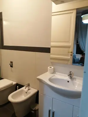 a white bathroom with a sink and a toilet at suite ruggero settimo in Palermo