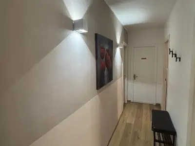a hallway with a wall light and a painting on a wall at Enne's Apartments in the heart of Palermo in Palermo