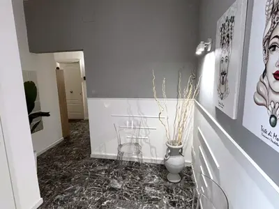 a hallway with a vase on the floor and a hallway with at Enne's Apartments in the heart of Palermo in Palermo