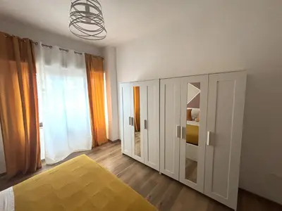 a bedroom with a bed and a cabinet and a window at Enne's Apartments in the heart of Palermo in Palermo