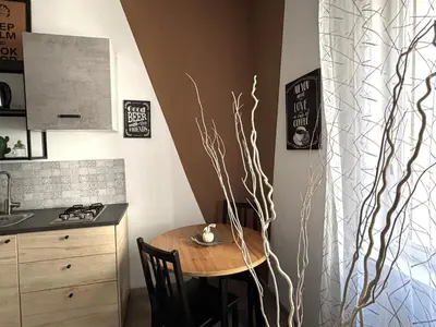 a kitchen with a small table and a counter and a sink at Enne's Apartments in the heart of Palermo in Palermo