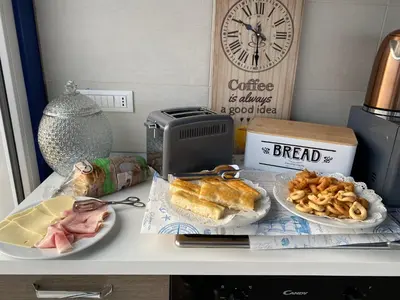 a table with two plates of food and a clock at B&B Torre Pozzillo in Cinisi