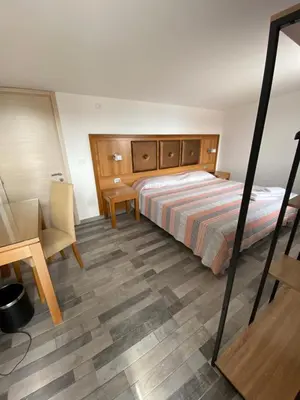 a bedroom with a bed and a desk and a chair at B&B Torre Pozzillo in Cinisi