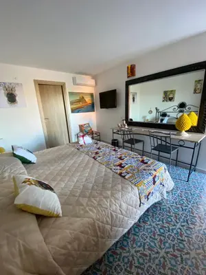 a bedroom with a large bed with a large mirror at B&B Torre Pozzillo in Cinisi