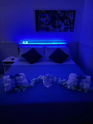 a blue room with a bed with flowers on it at Casetta Blu Mondello zona Partanna in Palermo