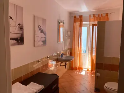 a bathroom with a sink and a toilet at Casa arancio in Palermo