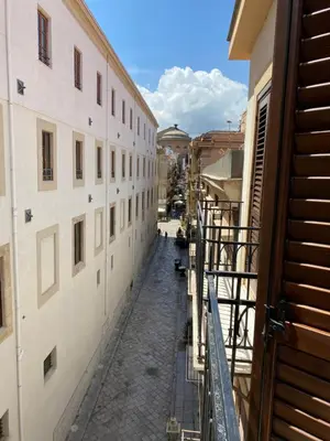 a view of an alley between two buildings at Casa arancio in Palermo