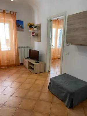 a room with a bed and a television in it at Casa arancio in Palermo