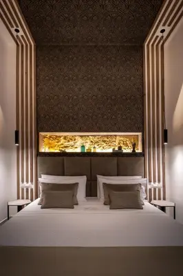 a bedroom with a large white bed with lights above it at Zisa Suite in Palermo