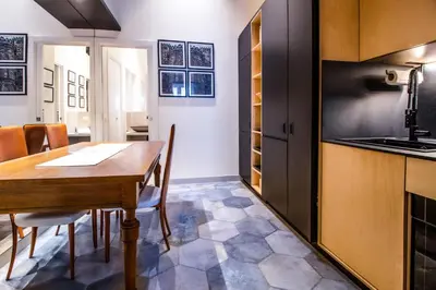 a kitchen and dining room with a wooden table at Zisa Suite in Palermo