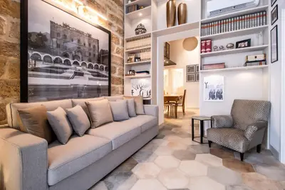 a living room with a couch and a chair at Zisa Suite in Palermo