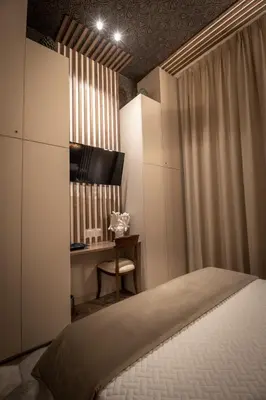 a bedroom with a bed and a desk at Zisa Suite in Palermo