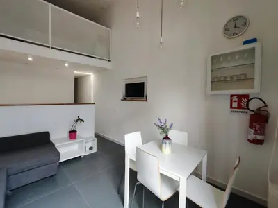 a living room with a white table and chairs at A NICAREDDA in Palermo