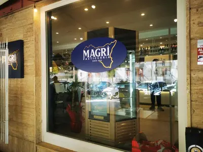 a window of a store with a sign on it at Large Room e Small Private Bathroom Between Mondello Beach and Old Town! Free Park! in Palermo