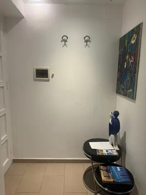 a room with a table and a clock on the wall at ART GALLERY HOUSE La casa dell’arte in Palermo
