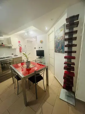 a kitchen with a dining room table and a room with at ART GALLERY HOUSE La casa dell’arte in Palermo