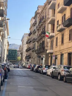 a street with cars parked on the side of a building at ART GALLERY HOUSE La casa dell’arte in Palermo