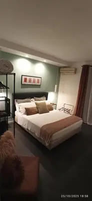 a bedroom with a large bed in a room at Jacona 365 in Palermo