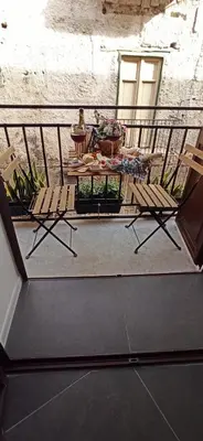 a balcony with two chairs and a table on a patio at Jacona 365 in Palermo