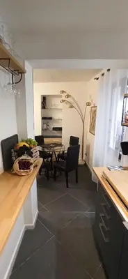 a kitchen and dining room with a table and chairs at Jacona 365 in Palermo