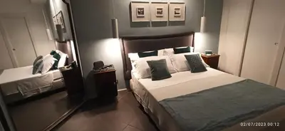 a bedroom with a large bed and a mirror at Jacona 365 in Palermo