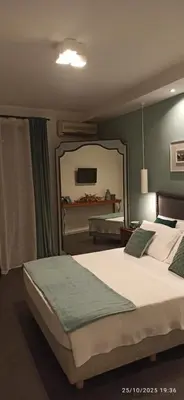a bedroom with two beds and a large mirror at Jacona 365 in Palermo