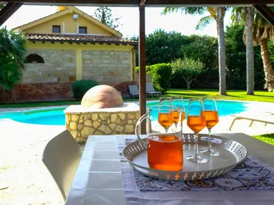 a table with glasses of orange juice on it at Villa Carta Fashion by Interhome in Terrasini
