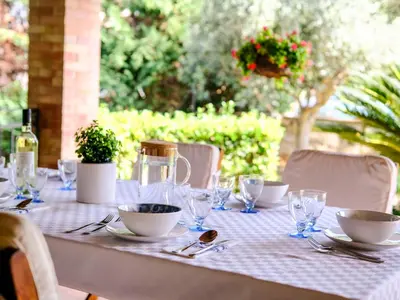 a table with plates and bowls and glasses on it at Villa Carta Fashion by Interhome in Terrasini